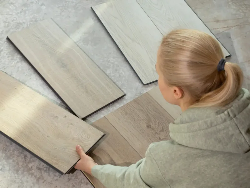 Homeowner looking at eco-friendly flooring samples